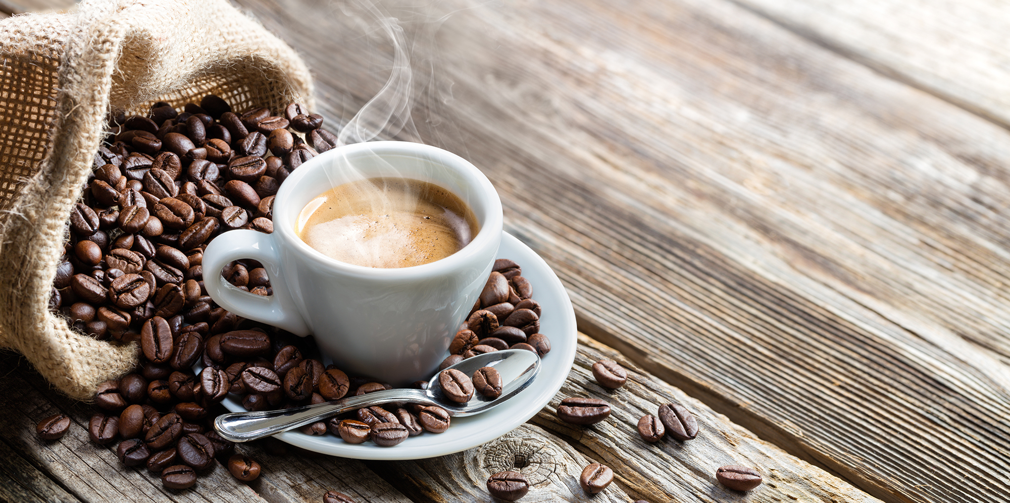 Espresso Coffee Cup With Beans On Vintage Table
